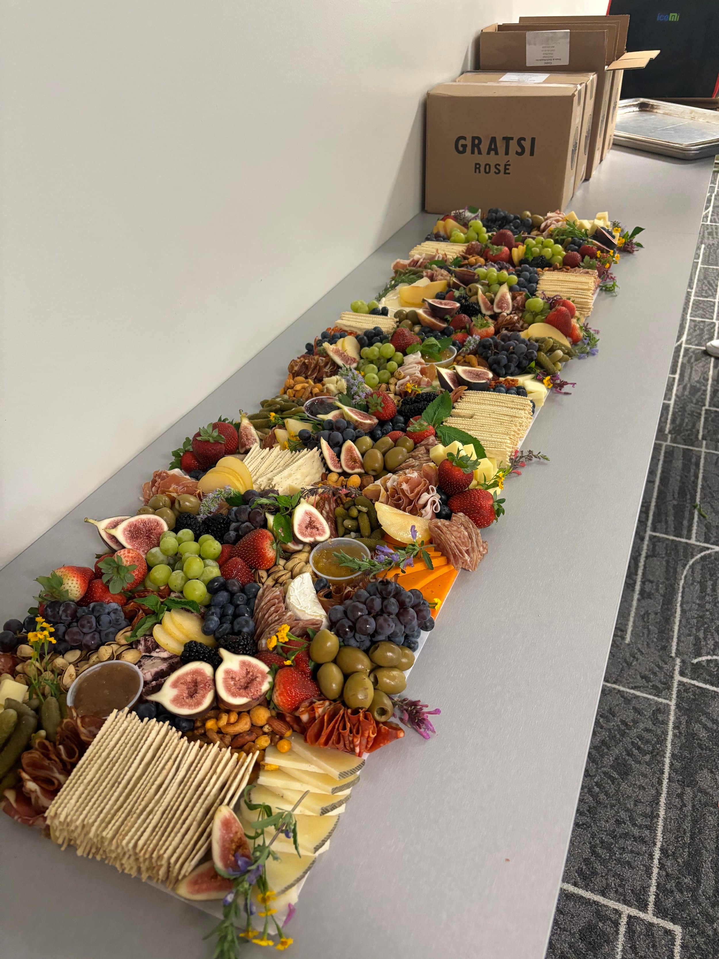 Luxury retail grazing table installation with artisanal cheeses and premium charcuterie for special events